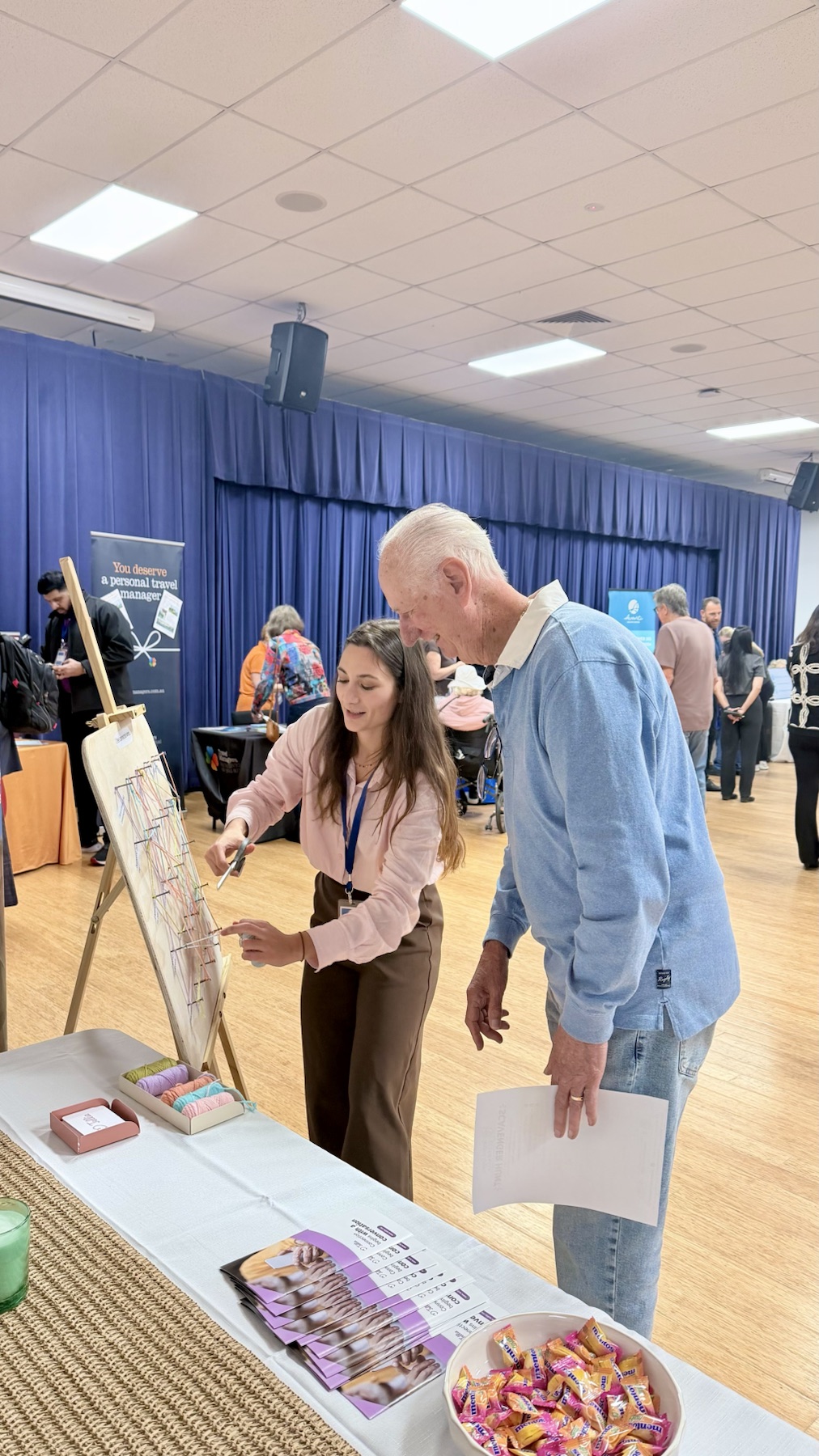 Tellie founder Micaela Piacenza speaking with an older adult at Seniors Expo Australia